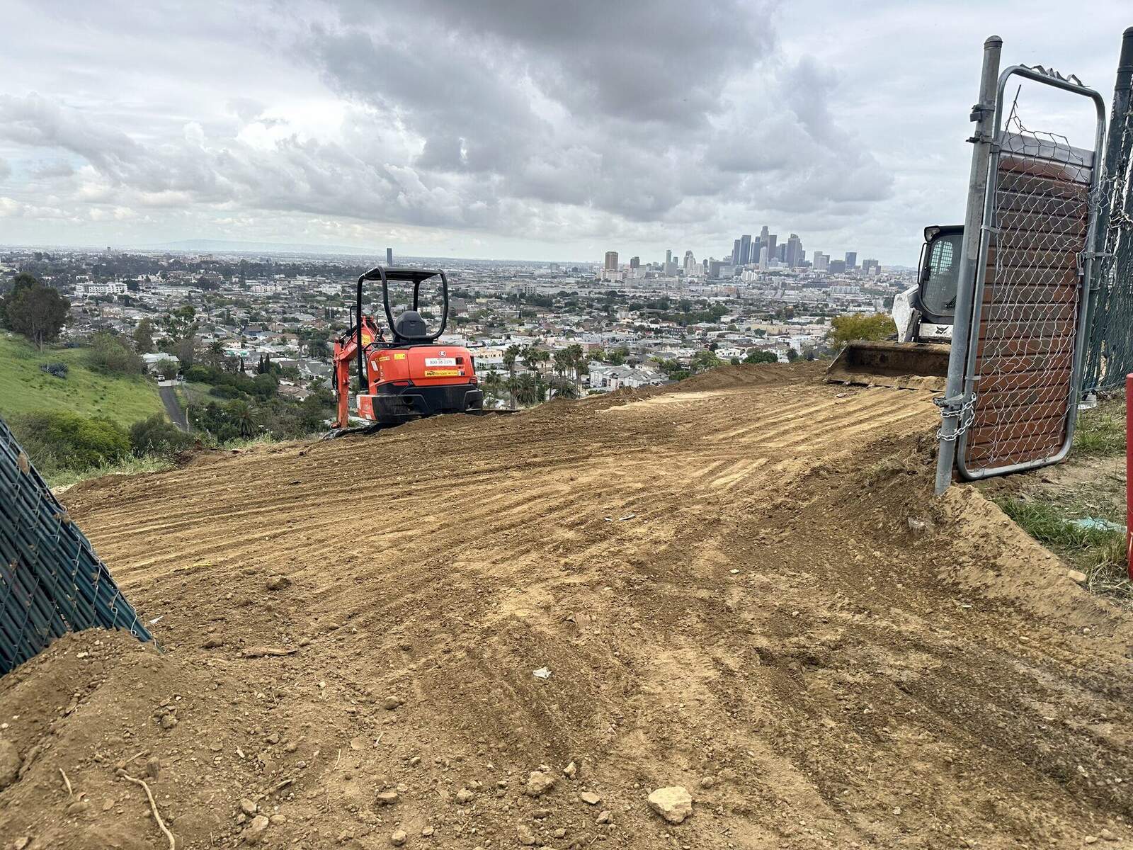 Excavator digging a foundation on a residential lot